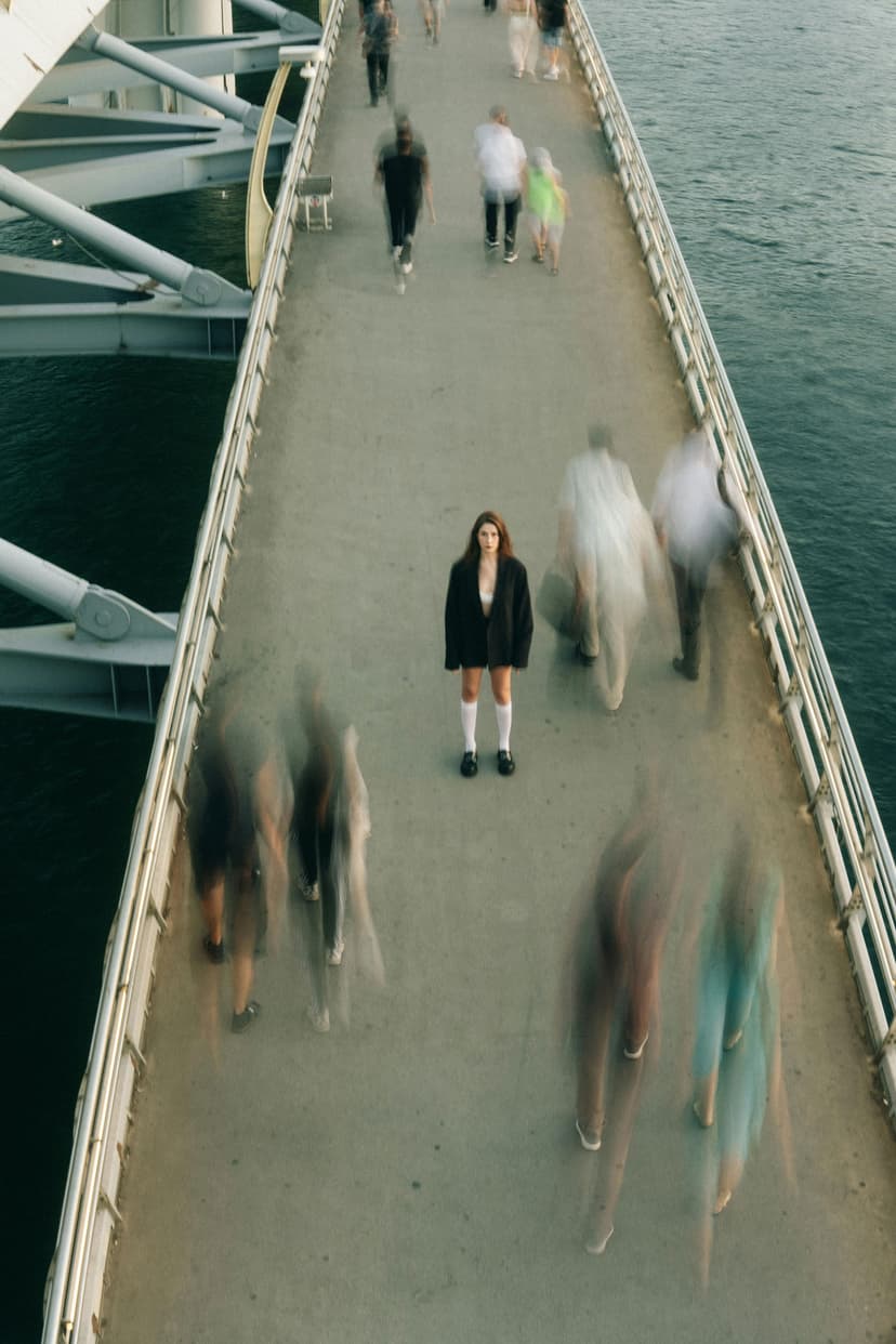 A woman standing on the sidewalk